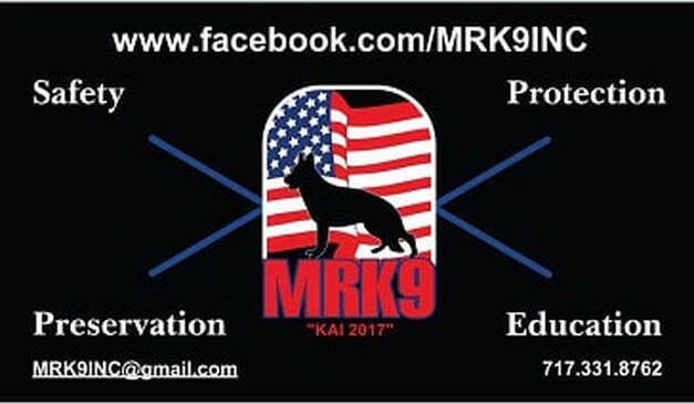 MRK9 Logo MRK9 Inc. Non profit dog rescue, red, white, and blue flag, with a Black Bear German Shepherd in front of it. Their model, Safety, Protection, Preservation, Educate words in the four corners. With the website MRK9Inc.org and their phone number 717-3312-8762 all on a black background