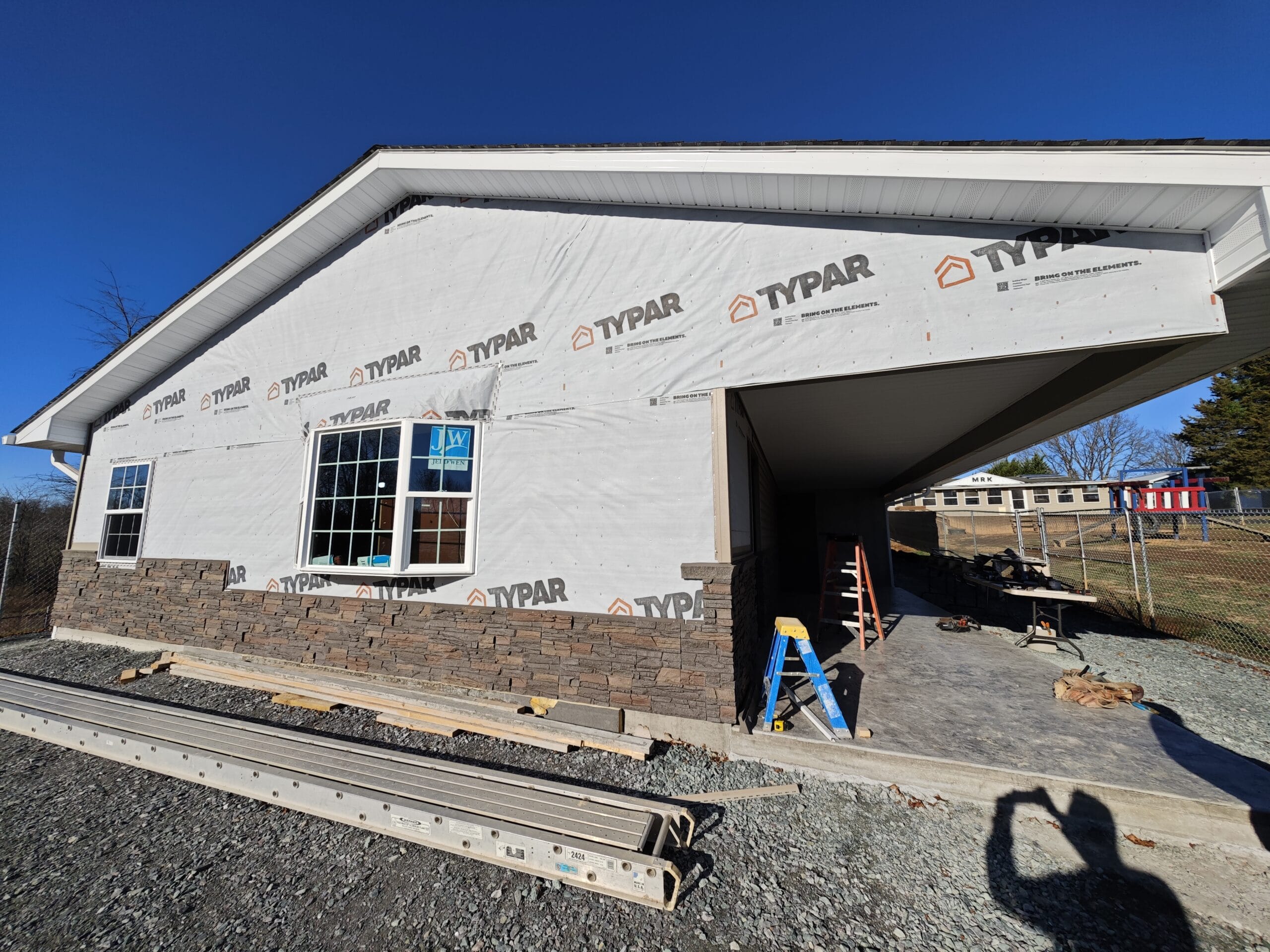 Marsh Run Kennels new kennel being built. Contractor adding the stone bottom on the front of the building.